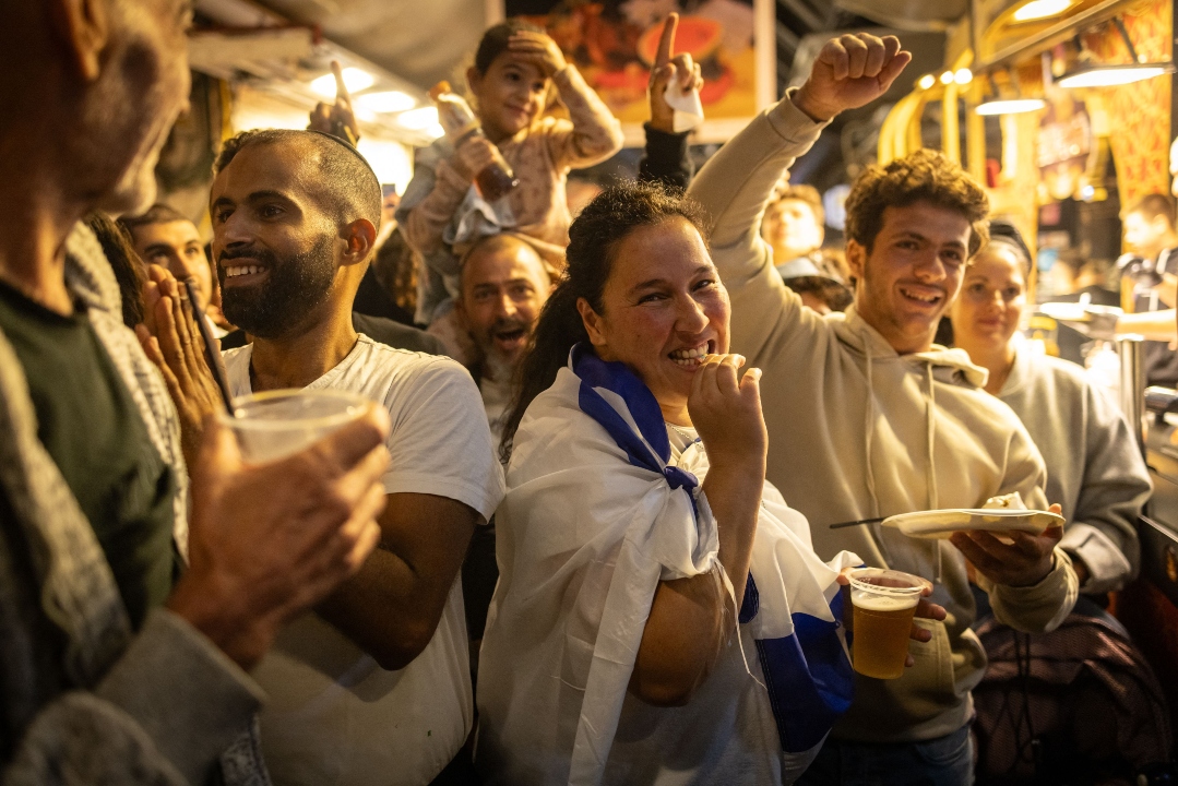 In Netanya, revelers dance and wave Israeli flags in celebration of the death of Hamas leader Yahya Sinwar, marking a significant moment in Israel's ongoing conflict with the group